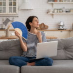 a person sitting on a couch holding a blue frisbee
