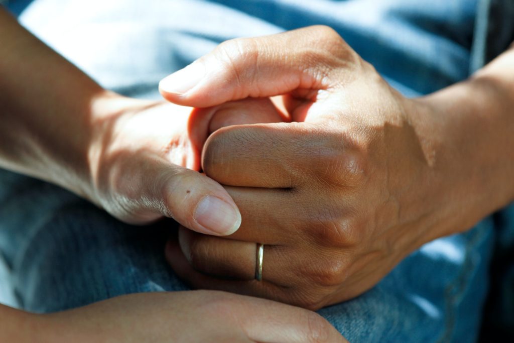 a close-up of a person holding a baby's hand