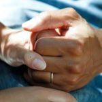 a close-up of a person holding a baby's hand
