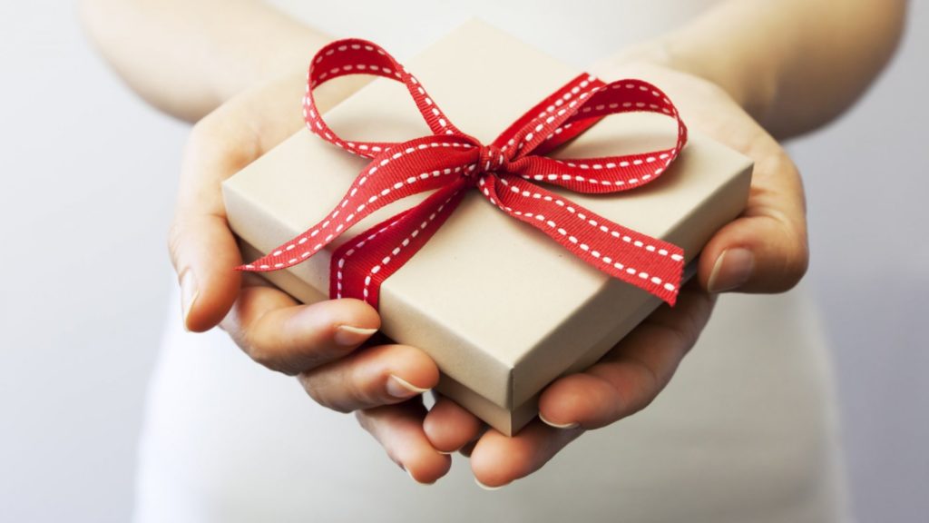 a hand holding a red heart shaped object