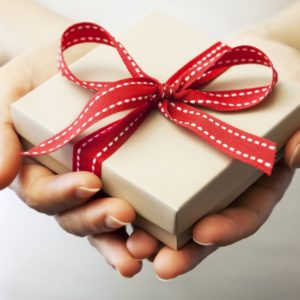 a hand holding a red heart shaped object