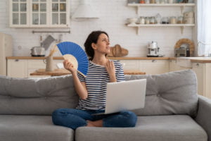 a person sitting on a couch holding a blue frisbee