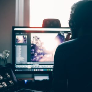 a person sitting in front of a computer screen