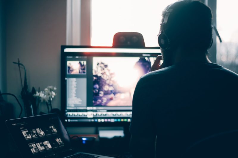 a person sitting in front of a computer screen