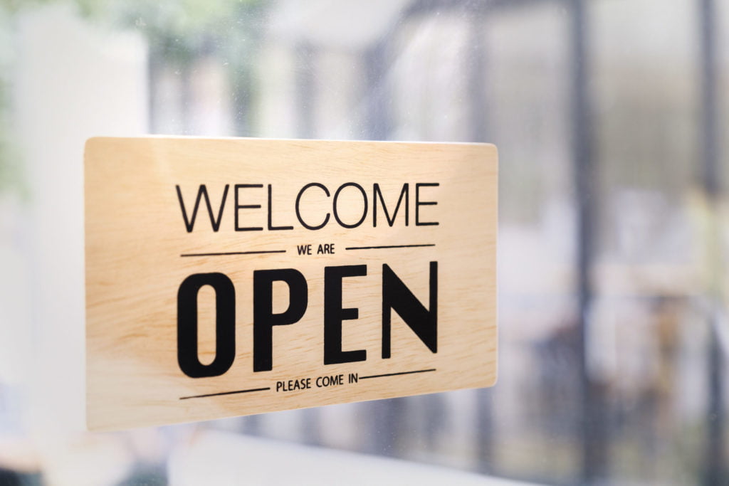 a wooden sign with black text