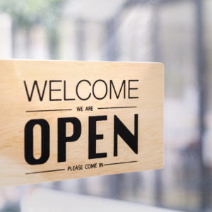 a wooden sign with black text
