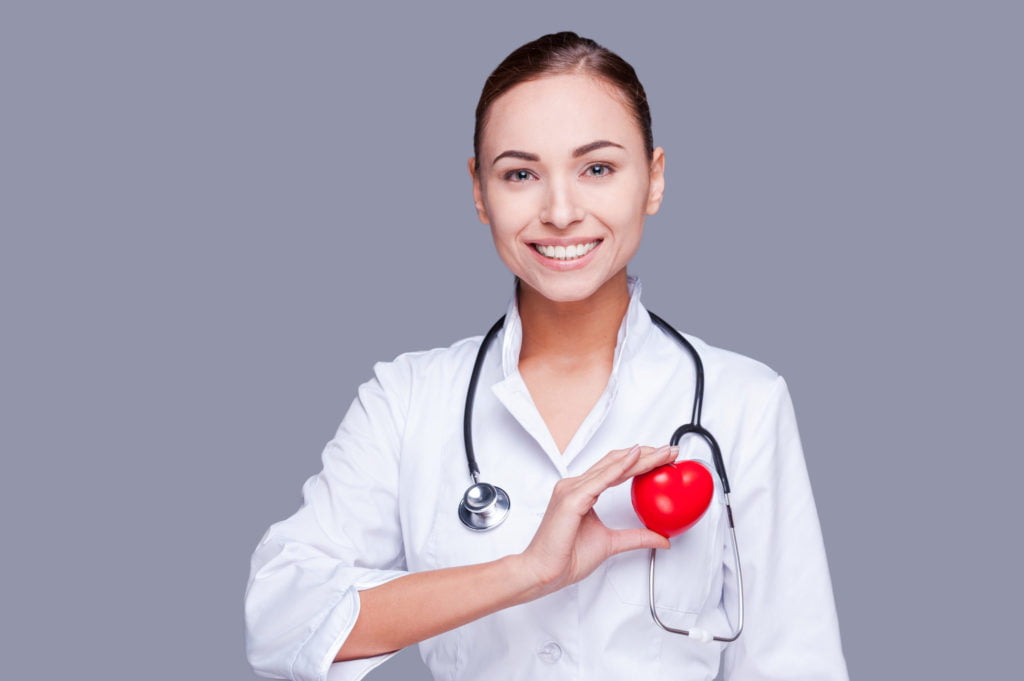 a doctor holding a red ball