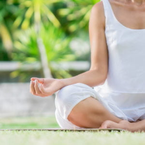a woman meditating on the ground