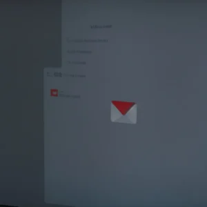a computer screen displays an inbox with emails, some marked with a red shield icon.
